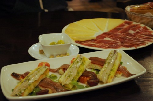 Anchovies over jam and toast, jamon serrano and cheese.